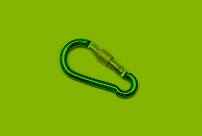 green carabiner clip on green background